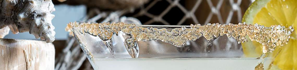 Close up of a margarita glass with a salted rim.